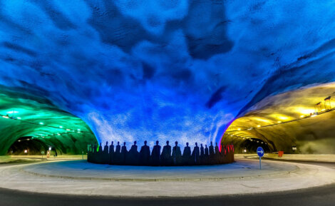 A tunnel is lit up with colorful lights.