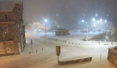 A street covered in snow at night.