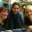 Three women posing for a photo at a restaurant.