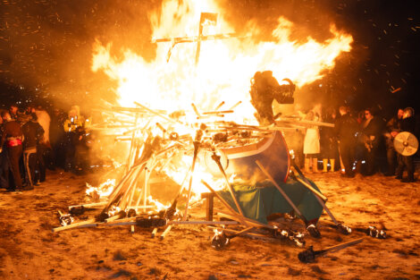 A large bonfire on the sand.