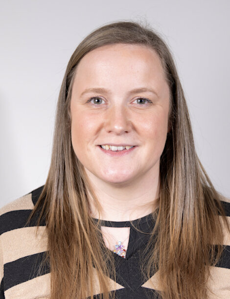 A woman with long hair and a striped top.