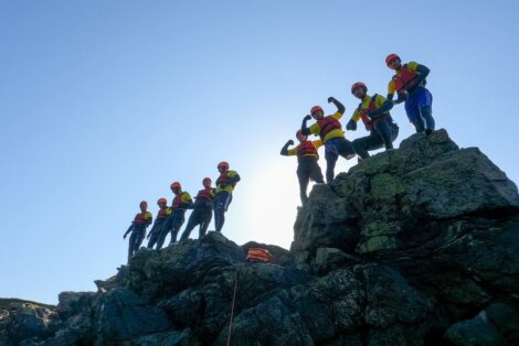 A group of people standing on top of a rock.