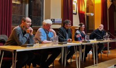 A group of people sitting at a table.