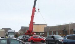 A crane lifting a car.