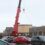 A crane lifting a car.