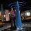 A woman standing next to a blue object in a museum.