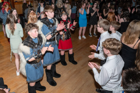 A group of people in costumes dancing at a party.