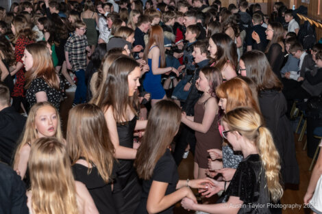 A group of people dancing in a large room.