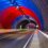 A tunnel with red, blue, and green lights.