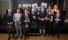 A group of people in kilts posing for a picture.