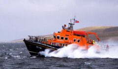An orange boat in the water.