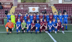 Youth football teams posing together at ochilview park stadium.