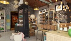 Interior of a cozy, rustic boutique store with shelves stocked with various items, including bottles and jars, under warm lighting.