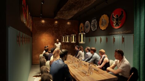 A bartender presenting to seated patrons at a dimly lit tasting room decorated with wall art and serving beer samples.