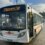 A sightseeing tour bus parked at a station on a sunny day.