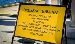 Yellow sign at Bressay Terminal announcing Linkspan works from May 24 to May 26, 2024. It directs foot passengers via a gangway from Heogan and provides a contact number for more information.