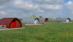 Three modern arch-shaped houses with varying facades, located on a green meadow dotted with yellow flowers under a clear sky.