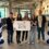 Five young individuals stand holding a banner that reads "Young Islanders Network" between two balloon columns with "Big Ideas" signs at the top in an indoor setting.