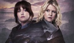 Two women stand back-to-back, one with dark hair and the other with blonde hair, with a scenic landscape superimposed on their clothing.