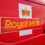 Close-up of a red Royal Mail vehicle featuring the Royal Mail logo and a crown emblem on the side.
