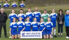 A co-ed sports team in blue and white uniforms poses for a group photo on an outdoor field with four adults and a sponsorship banner; inset shows headshots of four players.