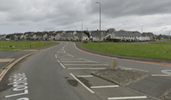 A curved road labeled "S Lochside" runs alongside a grassy area, with houses and streetlights visible under an overcast sky.