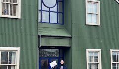A man standing in front of a building.