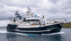 A large fishing vessel named "Opportune" with identification LK 209 sails on the water under a cloudy sky, with land visible in the background.